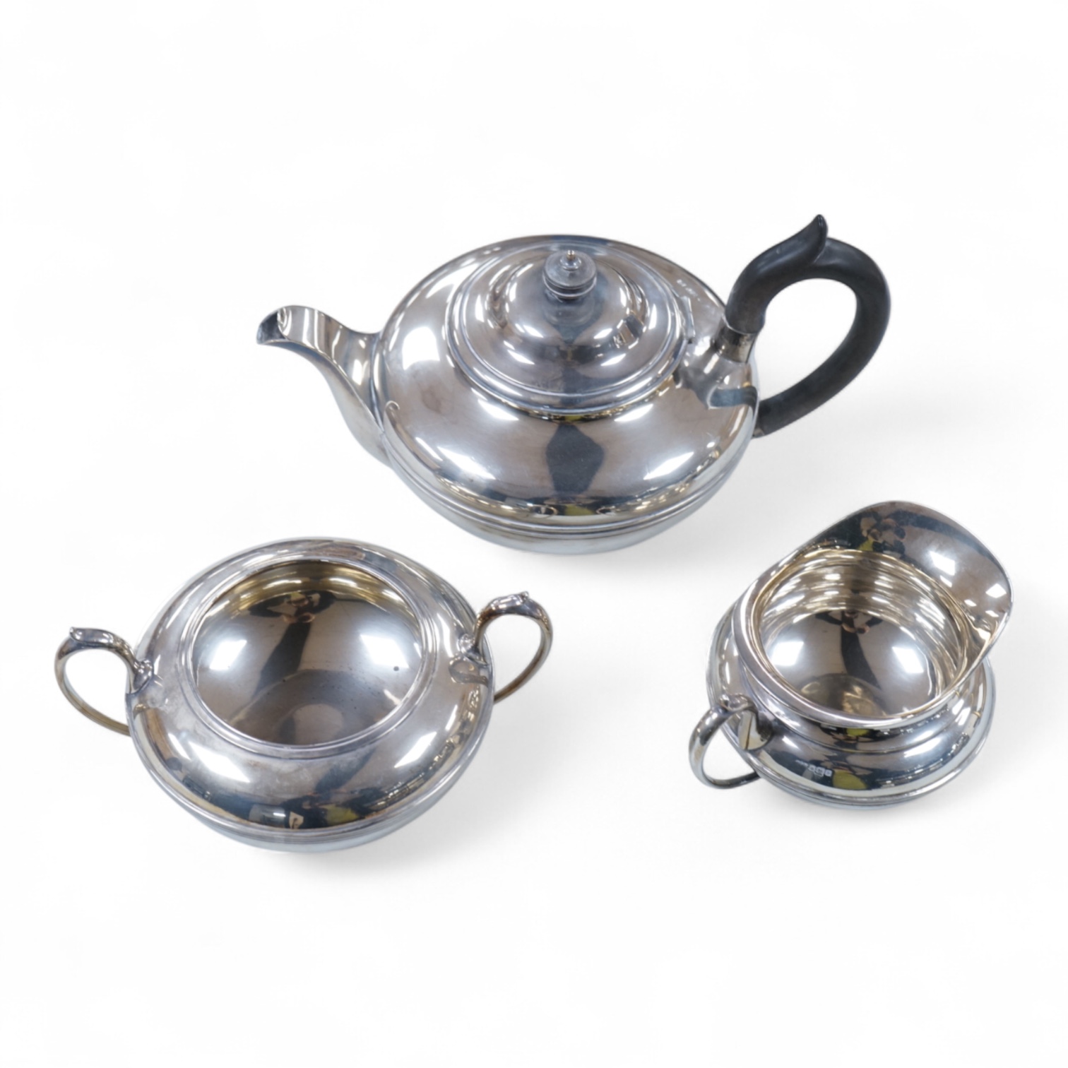 A George V three piece silver tea set, each piece of compressed globular form by James Dixon and Sons, Sheffield 1910, 1025g gross